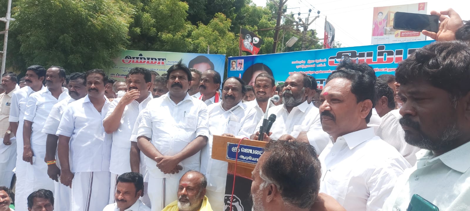 In Theni AIADMK members protested against the increase in electricity tariff and the law and order disorder